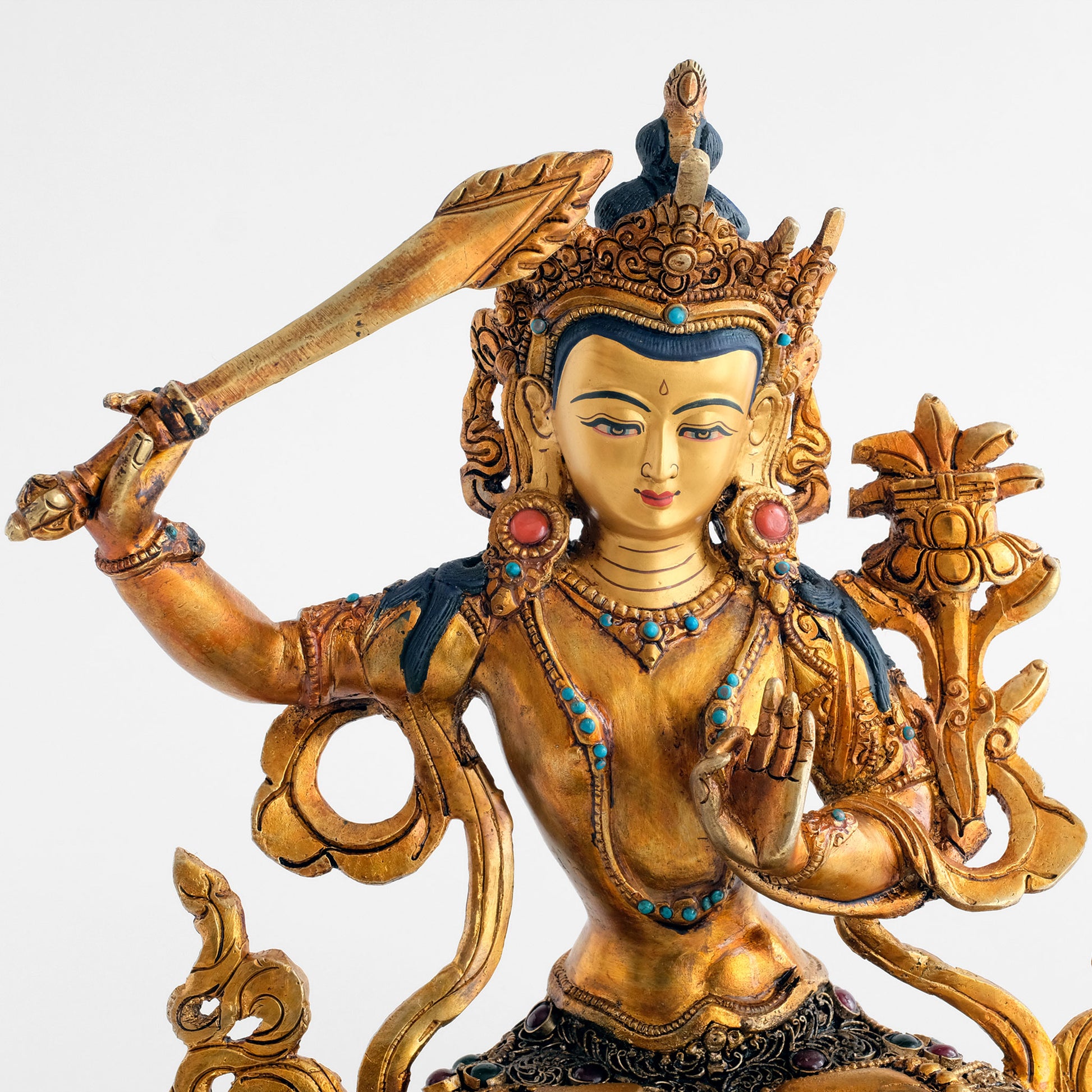 Details of the Manjushri statue. He wears the five pointed crown and full ornaments of a Bodhisattva. 