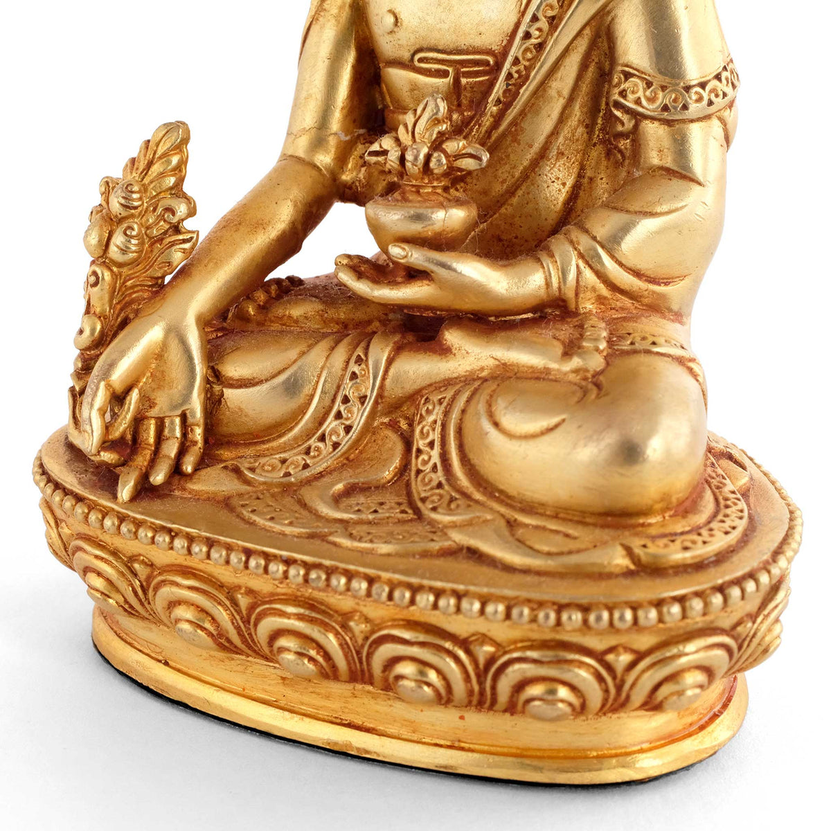 Kleine vergoldete Medizin Buddha Statue, Detailaufnahme der Hand mit dem Myrobalanen-Zweig und der Medizinschale.