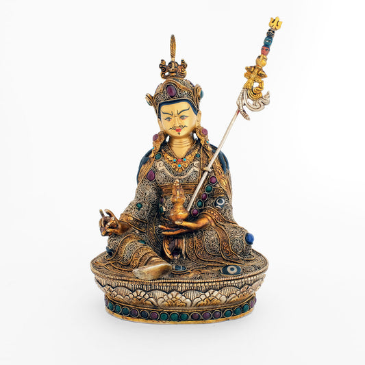 Padma Sambhava (Guru Rinpoche) Statue, Körper aus Kupfer gegossen, verziert mit filigranen Ornamenten, versilbert und vergoldet, besetzt mit bunten Steinen. Das Gesicht ist in Gold gefasst.