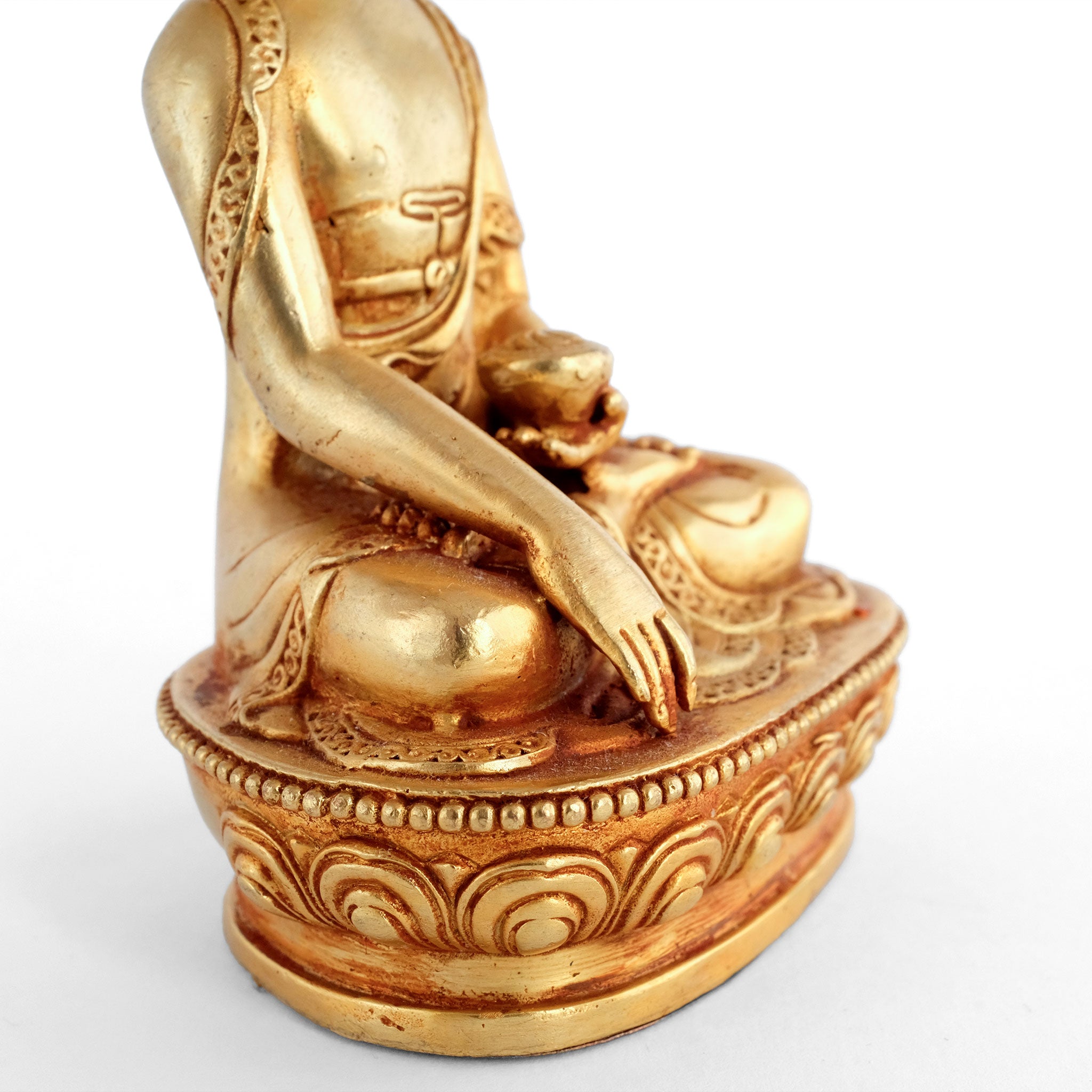Gold plated small Shakyamuni Buddha statue, his right hand in Bhumisparsa Mudra.