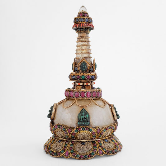 Stupa aus Kupferblech und Kristallquarz, verziert mit Filigran, versilbert und vergoldet, besetzt mit farbigen Steinen, Lapislazuli und Koralle. Aufgesetzte kleine Buddha geprägte Votivtafeln. 