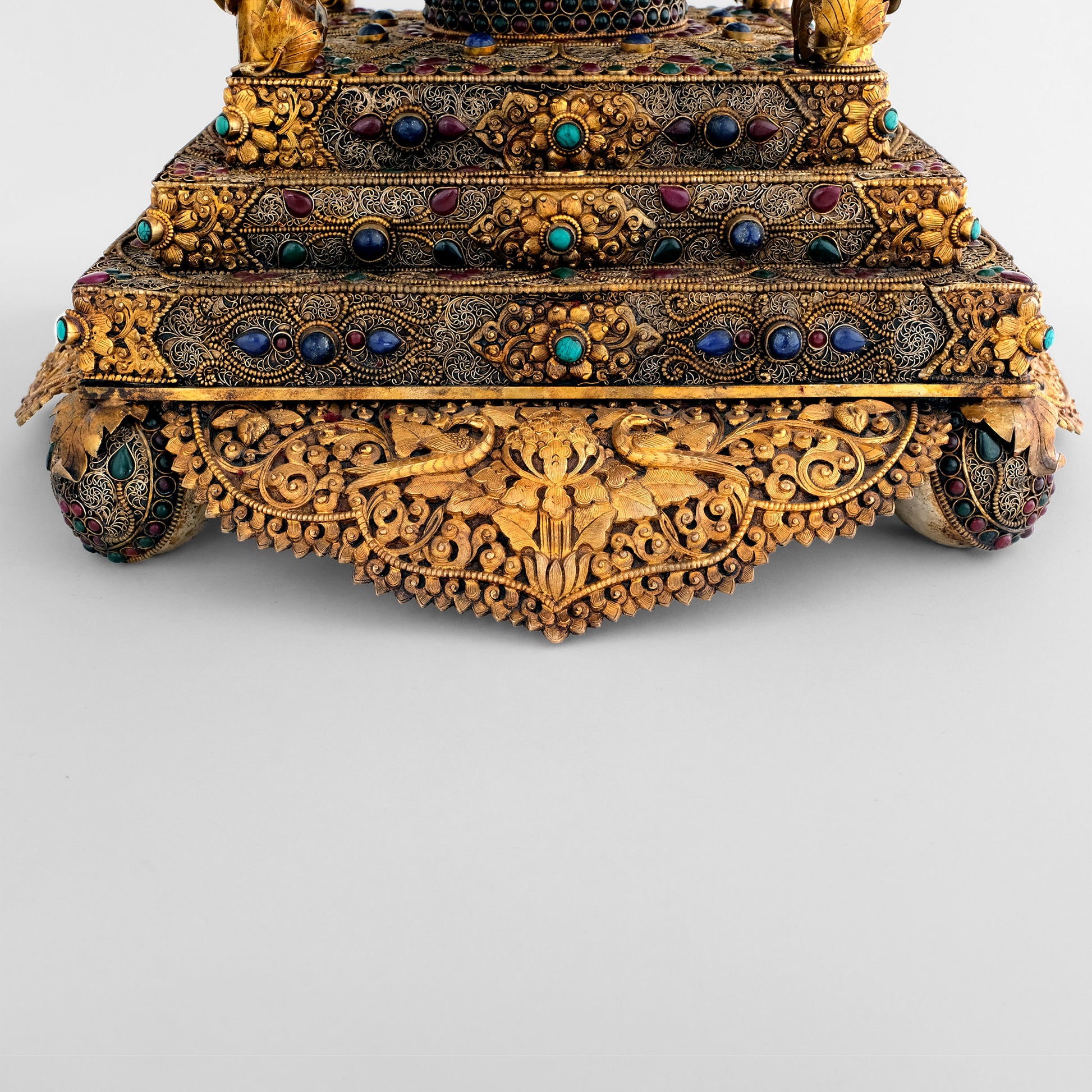 Stupa in Temple, the metal shields are decorated by repoussé and chasing. The stairs are adorned with fine filigree and gemstones. 