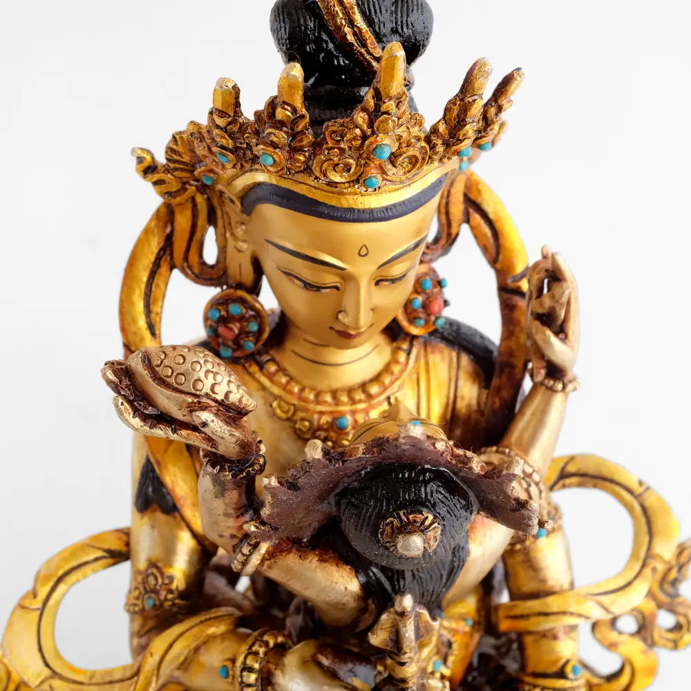 Vergoldete Vajrasattva Statue mit türkisfarbenen Akzenten. Er hält seine Gefährtin in den Armen.